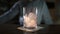 Bartender adds some ice to the glass before making cocktail, alcohol drink, making fresh cold drinks in a bar, work of