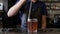 Bartender, barman preparing an alcoholic beverage, drink in nightclub, pub or bar