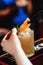 The bartender decorates refreshing cold cocktail with orange slice. Close-up.