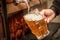 Bartender filling up with a blonde craft beer into a pint glass