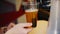 Bartender fills cup with fresh beer in cafe close view