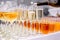 Bartender fills a glass of chilled champagne in crystal glasses that are on the table, next glasses with orange juice