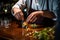 A bartender garnishing a cocktail with precision, adding the final touches of zest, herbs, or fruit to enhance the drink\'s