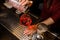 Bartender girl pouring the last straw of a campari cocktail