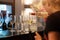 Bartender girl pours white wine into glasses. Restaurant bar, wine party.