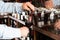 Bartender hand pouring draught red wine to glass