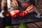 Bartender hands chopping red bell pepper