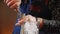 Bartender hands pouring cocktail ingredients in measuring cup or jigger