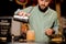 Bartender making orange cocktail