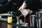 Bartender making relaxing cocktail on a bar background