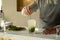 Bartender mixes an alcoholic mojito cocktail with a spoon