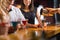 Bartender pouring cocktail for customers