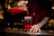 Bartender pouring fresh salty tomato alcoholic drink into a glass