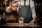 Bartender pourring a delicious alcoholic drink from a mixing glass