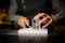 Bartender preparing a large rectangular piece of ice