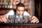 Bartender preparing and lining shot glasses for alcoholic drinks