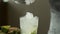 Bartender puts broken ice in a glass while making a mojito cocktail