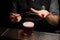 Bartender putting cherry on a toothpick with forceps