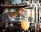 Bartender`s hand holding a botlle with alcohol drink and puring