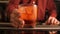 Bartender serves a Negroni cocktail on the bar counter