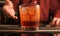 Bartender serves a Negroni cocktail on the bar counter