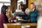 Bartender Serving Coffee To Women