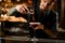 Bartender sprinkles an alcohol cocktail with spices