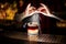 Bartender sprinkling orange juice into a glass of sweet flaky cocktail