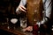 Bartender stirring alcohol cocktail with special spoon