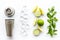 Bartender work desk with equipment and cocktail ingredietns Shaker, lime, ice on white background top-down