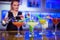 Bartender working with cocktail glasses on counter