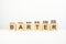 barter - text written on wooden block with stacked coins on white background, growing trend