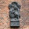 Bas-relief of monarch in bronze on brick wall in Muiderslot castle. Holland