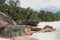 Basalt boulders on sandy beach. Baie Lazare, Mahe, Seychelles