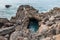 Basalt rocks in the ocean. Volcanic texture of rocky coastline
