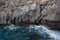 Basalt rocks in the ocean. Volcanic texture of vertical columns at the coast