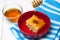 Basbousa - arabian cake with almonds and honey syrup in bowl on white wooden background