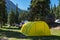 Base camp in forest near foothills. Base camp equipment and tents in mountains. Travel, tourism concept. Barskoon river gorge