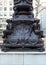 Base of the flagstaff with bronze sculptural decorations, details, at the NY Public Library Building