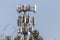 A Base transceiver station towering above trees at a rural location.