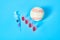 Baseball ball near syringe and ampoule on blue background. Concept of doping in professional sport