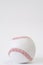 baseball ball with red threads on white paper background