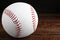 Baseball ball on wooden table, closeup with space for text. Sportive equipment