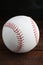 Baseball ball on wooden table, closeup. Sportive equipment