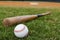 Baseball and Bat on Field