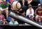 Baseball bat hitting ball with spectator background