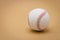 baseball on a brown background and red stitching baseball. White baseball with red thread.Baseball is a national sport of