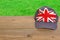 Baseball cap with British flag on wooden table