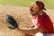 Baseball catcher crouching on field