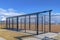 Baseball field dugout with slanted roof and chain link fence on a sunny day